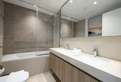 a bathroom with a sink and a tub and a mirror at Signature Luxury Apartments Downtown Dubai in Dubai