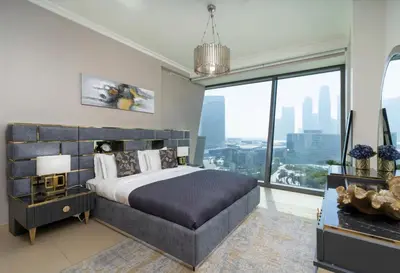 a bedroom with a large bed and a large window at Prime Downtown Luxury Stays by Burj Khalifa in Dubai
