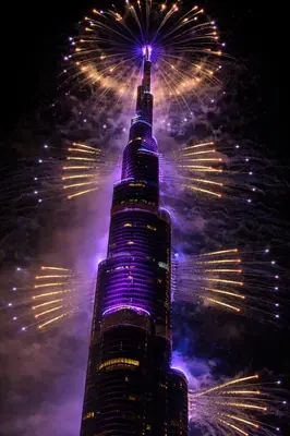 a tall building with fireworks in the sky at Prime Downtown Luxury Stays by Burj Khalifa in Dubai