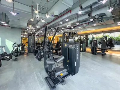 a gym with several treadmills and cardio machines at Cozy Studio with Balcony I Near Dubai Mall & Downtown in Dubai