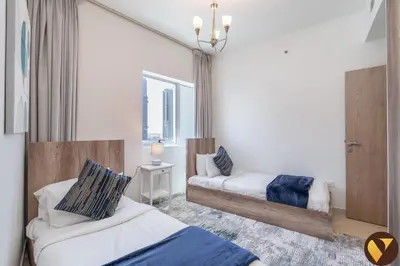 a bedroom with two beds and a window at Vogue Marina Diamond Near JBR Beach and Marina Mall, Two Bedroom Apartment with Balcony and City View, Access to all Amenities, Walkable to Sobha Realty Metro Station and Bus Stop in Dubai