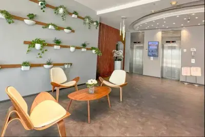 a waiting area with chairs and a table in a room at Vogue Marina Diamond Near JBR Beach and Marina Mall, Two Bedroom Apartment with Balcony and City View, Access to all Amenities, Walkable to Sobha Realty Metro Station and Bus Stop in Dubai