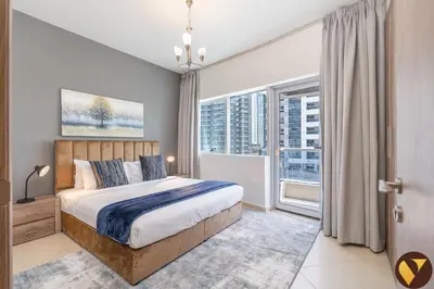 a bedroom with a large bed and a large window at Vogue Marina Diamond Near JBR Beach and Marina Mall, Two Bedroom Apartment with Balcony and City View, Access to all Amenities, Walkable to Sobha Realty Metro Station and Bus Stop in Dubai