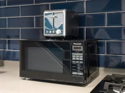 a toaster oven sitting on top of a microwave at Spacious Studio with Balcony I Near Dubai Mall & Downtown in Dubai