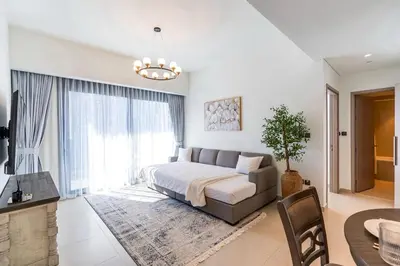 a bedroom with a bed and a couch and a table at Chic Downtown Act Tower Walk to Burj Khalifa&Mall in Dubai