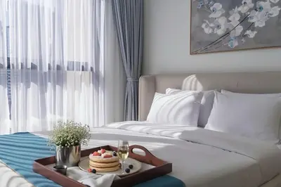 a hotel room with a tray of food on a bed at Chic Downtown Act Tower Walk to Burj Khalifa&Mall in Dubai