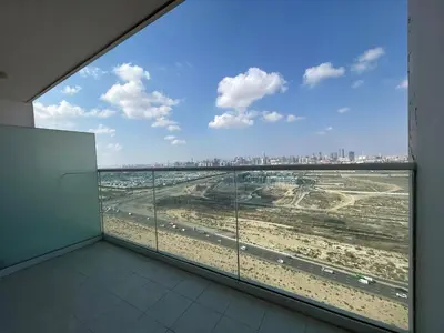 a large window in a building with a view of the city at Modern Luxury Studio Damac Hills With Golf View in Dubai