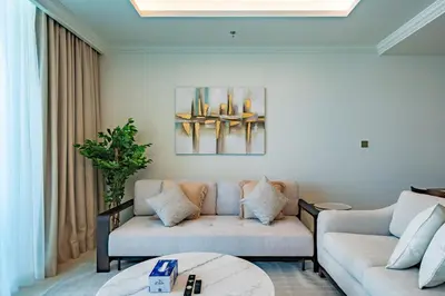 a living room with two couches and a table at Exquisite Beachfront 1BR l Palace Beach Residence in Dubai
