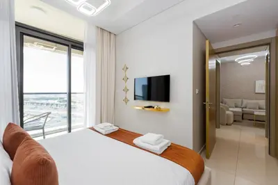 a bedroom with a large bed with a tv on the wall at Aykon City Tower C, Business Bay - Onelink in Dubai