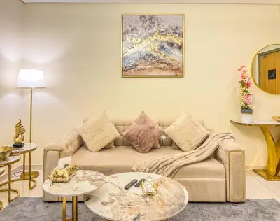 a living room with a couch and two tables at Iconic Burj Khalifa View 2BR Luxury apmt at Paramount Midtown in Dubai