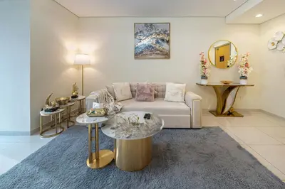 a living room with a couch and a table at Iconic Burj Khalifa View 2BR Luxury apmt at Paramount Midtown in Dubai