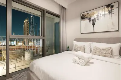 a bedroom with a bed and a large window at Exclusive Apartments in Burj Vista Downtown Dubai Near Burj Khalifa in Dubai