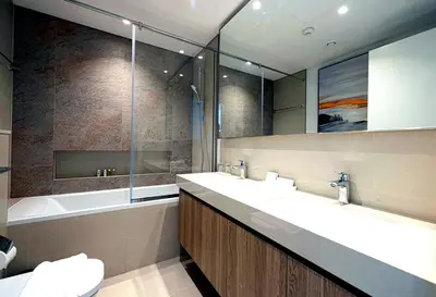 a bathroom with two sinks and a tub and a mirror at Exclusive Apartments in Burj Vista Downtown Dubai Near Burj Khalifa in Dubai