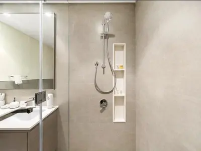 a shower in a bathroom with a sink at Exclusive Apartments in Burj Vista Downtown Dubai Near Burj Khalifa in Dubai