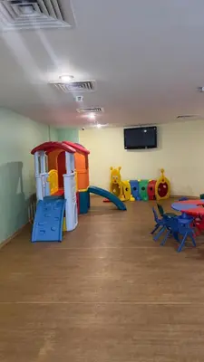 a play room with a slide and play equipment at Dubai Marina Apartment Steps to DMCC Metro & JBR in Dubai