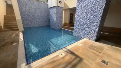 a swimming pool in a room with blue tiles at Dubai Marina Apartment Steps to DMCC Metro & JBR in Dubai