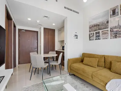 a living room with a couch and a table at Reva Residence Comfort Suite 1BDR Plus Sofa Bed in Dubai