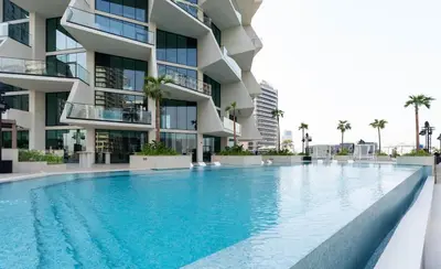 a swimming pool in front of a building at Platinum 1BR W Private Pool Binghatti Royale in Dubai