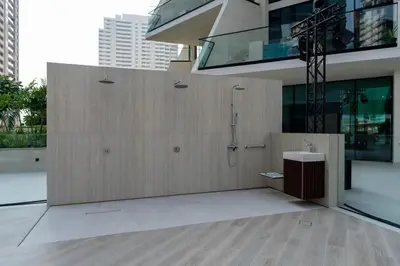a bathroom with a shower on the side of a building at Platinum 1BR W Private Pool Binghatti Royale in Dubai