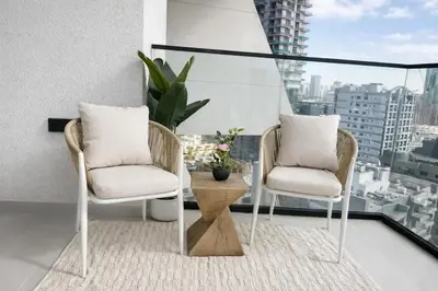 two chairs and a table on a balcony at Platinum 1BR W Private Pool Binghatti Royale in Dubai