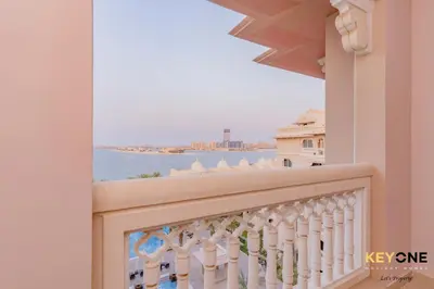 a balcony with a view of the ocean at Spacious Beachfront 2BR with Maids Room in Grandeur in Dubai