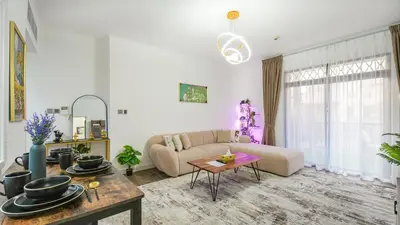 a living room with a couch and a table at Contemporary one-bedroom apartment in Burj Khalifa area by Norbu Holiday Homes in Dubai