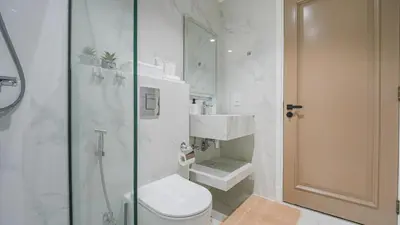 a bathroom with a shower and a toilet and a sink at Contemporary one-bedroom apartment in Burj Khalifa area by Norbu Holiday Homes in Dubai