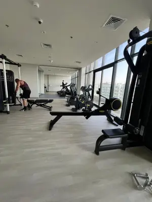 a gym with a bunch of treadmills in a building at The Comfort Cove Studio in Azizi Riviera 32 in Dubai