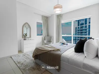 a bedroom with a large bed and a large window at Sea View 2BR in Dubai Marina near Dubai Eye in Dubai