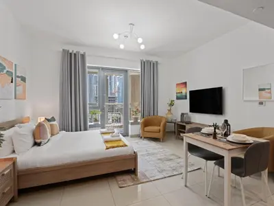 a bedroom with a bed and a living room at The Havenette comfy Studio in 29 BLVD Walk in Dubai
