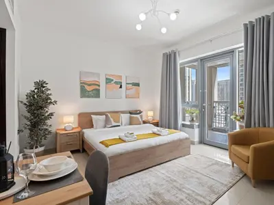 a bedroom with a king sized bed and a dining table at The Havenette comfy Studio in 29 BLVD Walk in Dubai