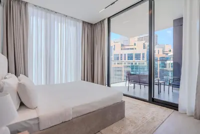 a bedroom with a bed and a large window at TRPS - Trillionaire Residences, Business Bay - Private Jacuzzi, Modern 2BR Furnished, Canal View in Dubai