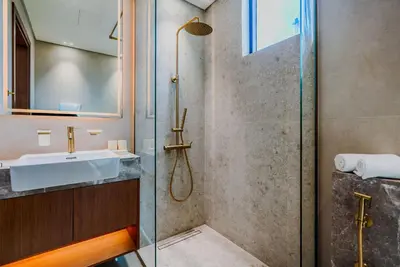 a bathroom with a sink and a shower at TRPS - Trillionaire Residences, Business Bay - Private Jacuzzi, Modern 2BR Furnished, Canal View in Dubai