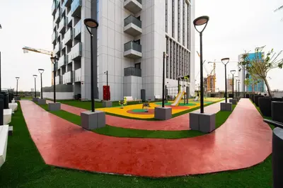 a playground in front of a building at SettlerHomes - Chic Cloud B - Pool, Gym & Court in Dubai