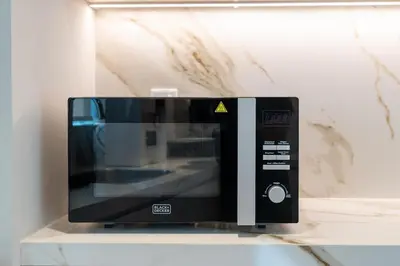 a microwave oven sitting on top of a counter at Bright & Modern 1BR in Dubai Marina in Dubai
