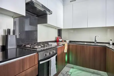a kitchen with a stove and a sink at Frank Porter - J One Tower in Dubai