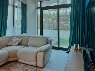a living room with a couch and a large window at Panoramic Apartment with Smart TV&Large Terrace in Dubai