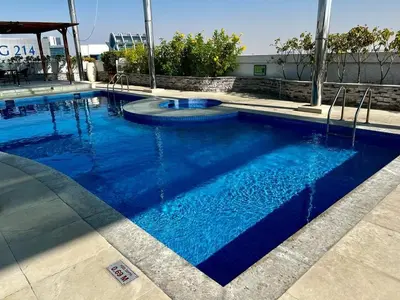 a large pool with blue water in a building at Dreamy heaven Spacious 2BR Apt with marina view in Dubai