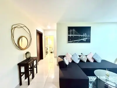 a living room with a blue couch and a mirror at Dreamy heaven Spacious 2BR Apt with marina view in Dubai