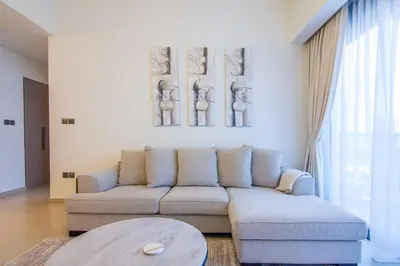 a living room with a couch and a table at One Bedroom Apartment with Balcony in Act One Act Two, Downtown in Dubai