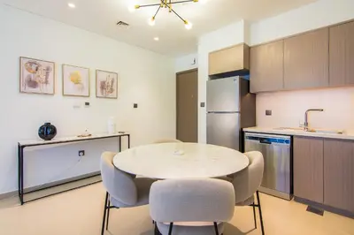 a kitchen with a table and chairs in a room at One Bedroom Apartment with Balcony in Act One Act Two, Downtown in Dubai
