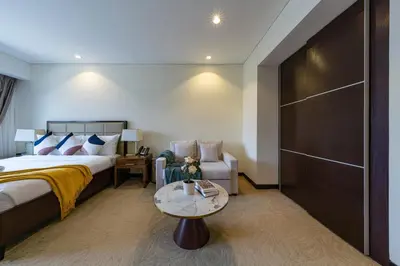 a bedroom with a bed and a couch and a table at Marina View Studio with Balcony in Dubai