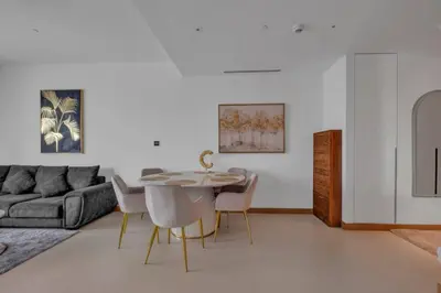 a living room with a table and chairs and a couch at Full Marina view luxury apartment in Dubai in Dubai