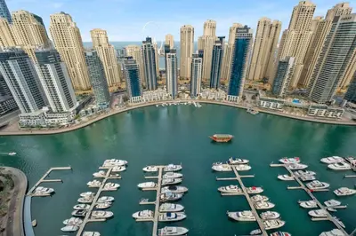 a group of boats in a marina in a city at Full Marina view luxury apartment in Dubai in Dubai