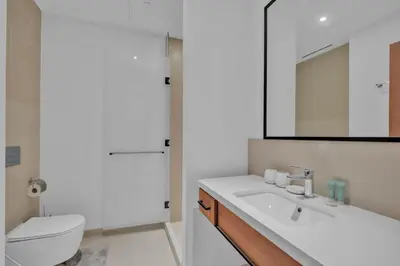 a bathroom with a sink and a toilet and a mirror at Full Marina view luxury apartment in Dubai in Dubai