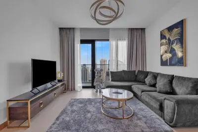 a living room with a couch and a tv at Full Marina view luxury apartment in Dubai in Dubai