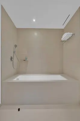 a white bathroom with a tub and a shower at Full Marina view luxury apartment in Dubai in Dubai