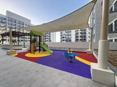 a playground with a slide and a swing at Vacationer l Modern Studio l Community Views l Free Gym, Pool in Dubai