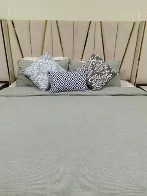 a bed with four pillows on top of it at ZAH Luxury Holiday Home at JBR,Dubai in Dubai
