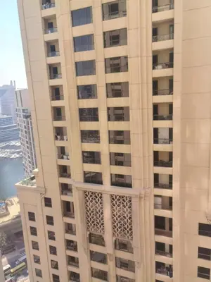 a tall white building with a lot of windows at ZAH Luxury Holiday Home at JBR,Dubai in Dubai